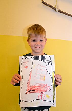 Aron Kirch, 4 Jahre alt aus Ingolstadt „Ich habe ein Haus gemalt, weil ich möchte, dass alles Kinder auf der Welt ein sicheres Haus haben. Die Kinder in dem Haus sollen immer etwas zu essen haben und viel Spielzeug.“ Foto: Kath. Kita IN gGmbH/Vogl